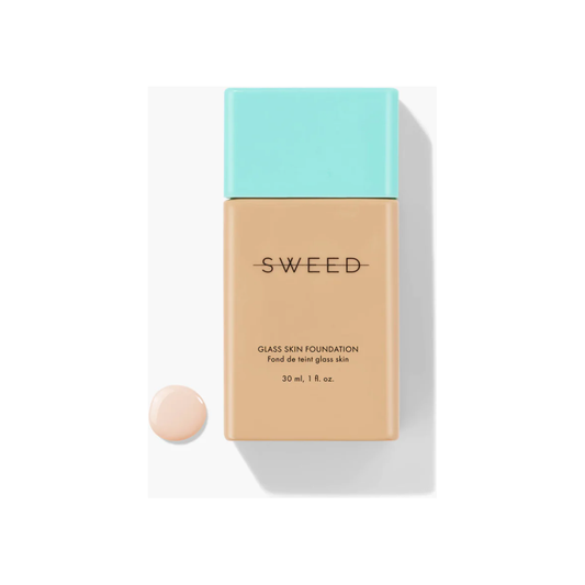 Foundation bottle with a swatch of product next to it on a white background.