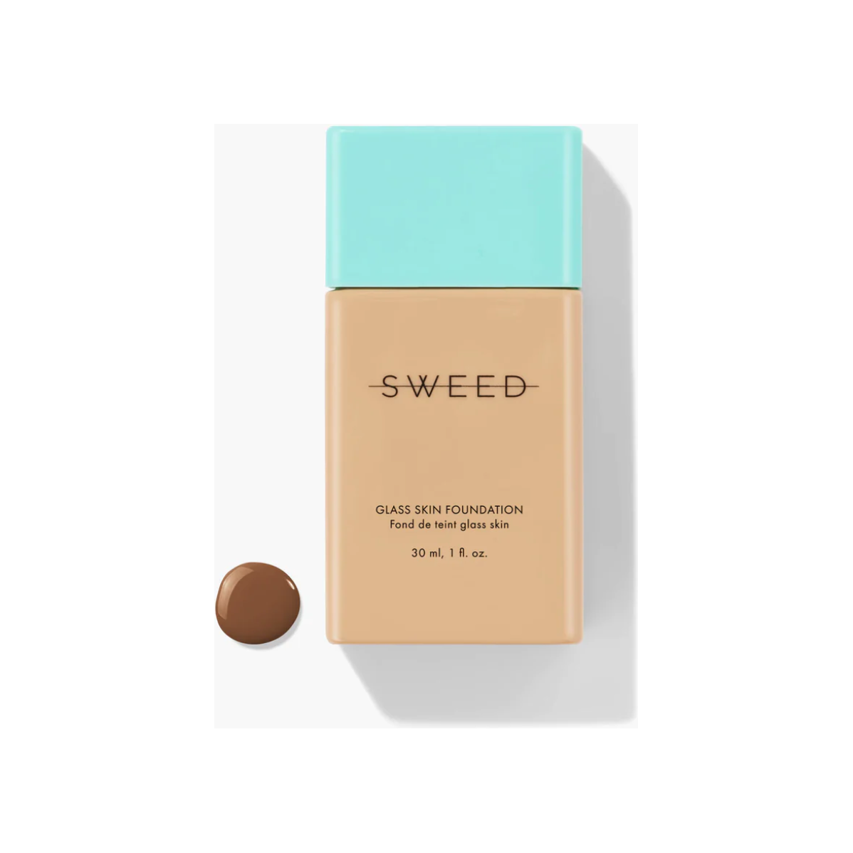 Bottle of liquid foundation with a sample of the shade next to it.