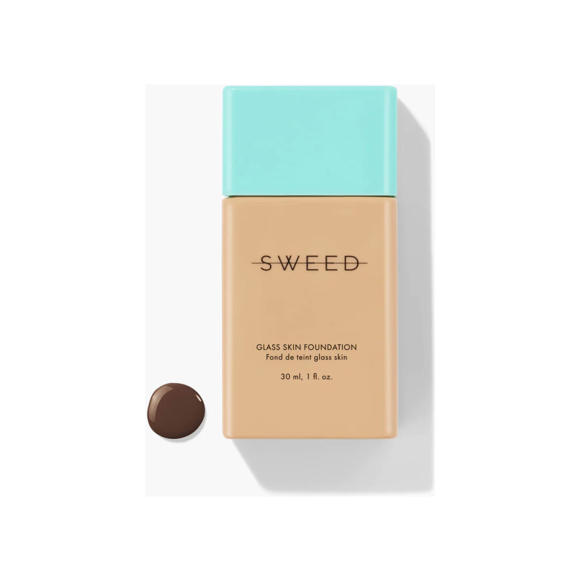 Bottle of liquid foundation with a turquoise cap, isolated on a white background.